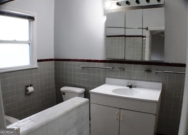 a bathroom with a sink and a window