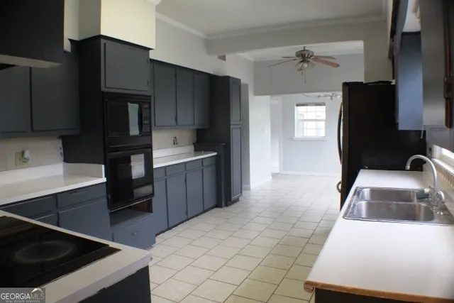 a kitchen with stainless steel appliances a sink stove and refrigerator