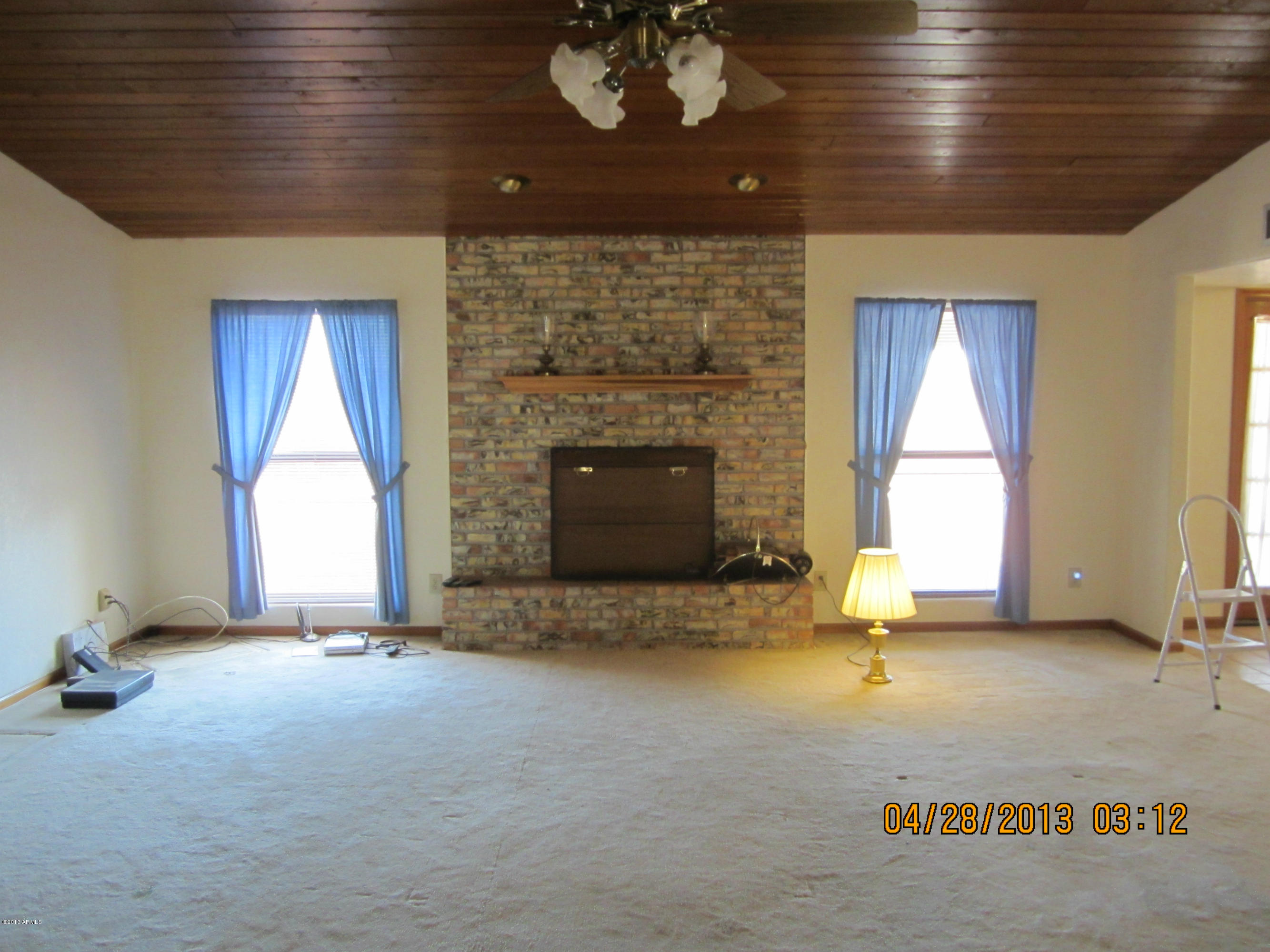 731 East Maddock Road Phoenix, AZ 85086 - Photo 13 of 19 a view of an empty room with a fireplace and a window