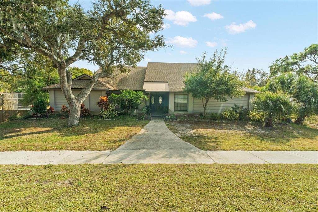 1245 Curlew Road Dunedin, FL 34698 - Photo 2 of 42 a view of swimming pool and trees in the background