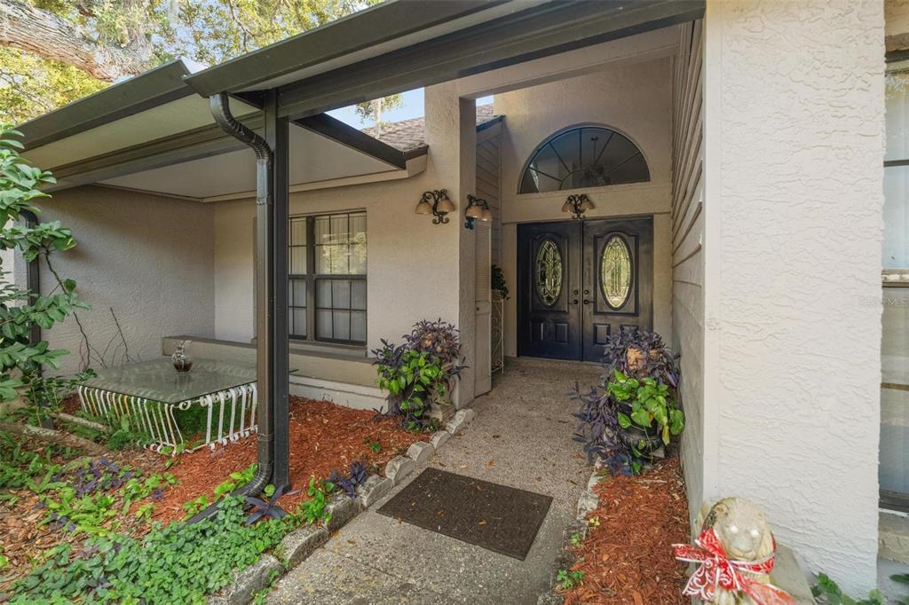 1245 Curlew Road Dunedin, FL 34698 - Photo 3 of 42 a front view of a house with garden