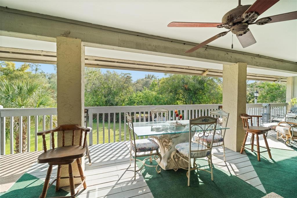 1245 Curlew Road Dunedin, FL 34698 - Photo 33 of 42 a view of a chairs and table on the deck