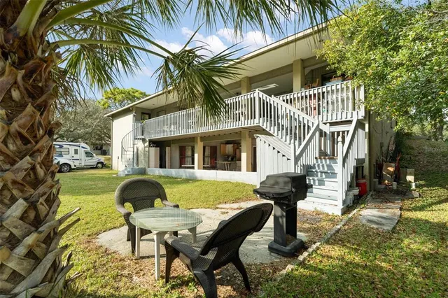 a front view of a house with garden and patio