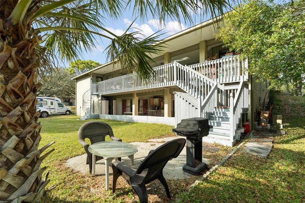 1245 Curlew Road Dunedin, FL 34698 - Photo 34 of 42 a front view of a house with garden and patio