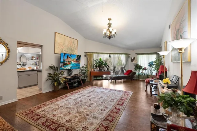 a living room with furniture a rug and a chandelier