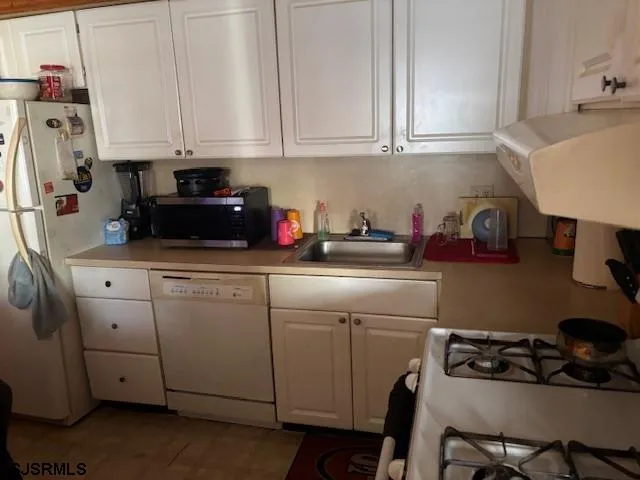 a kitchen with a sink appliances and cabinets