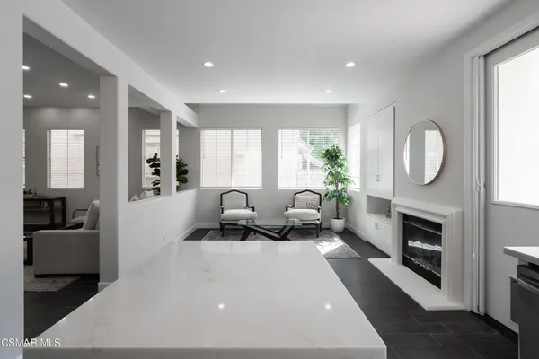 a living room with furniture a window and a fireplace