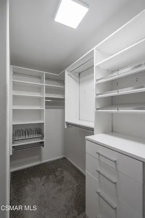 a bathroom with a granite countertop sink a toilet a mirror and shower