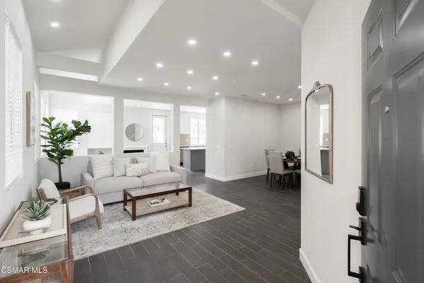 a living room with furniture and a potted plant