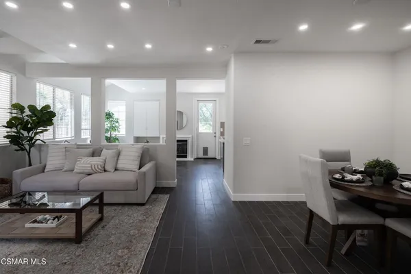 a kitchen with a sink white cabinets and white appliances