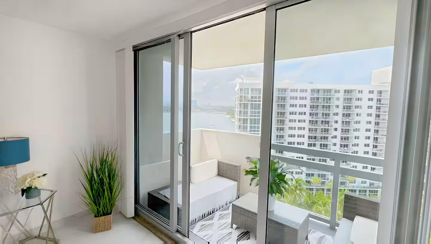 1500 Bay Road, Unit 1244S Miami Beach, FL 33139 - Photo 13 of 48 a room with balcony and glass door