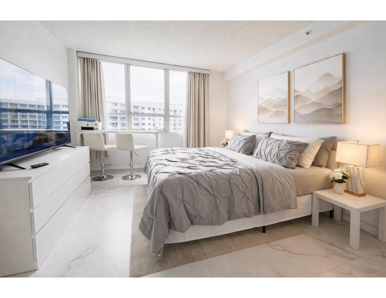 1500 Bay Road, Unit 1244S Miami Beach, FL 33139 - Photo 15 of 48 a spacious bedroom with a bed and a large window
