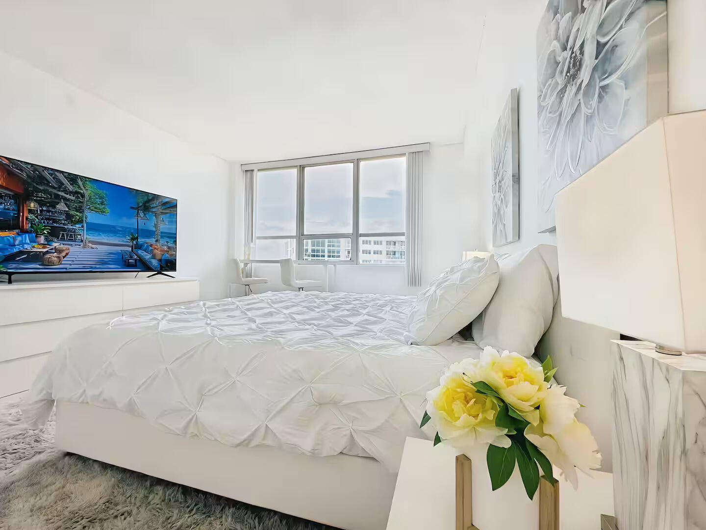 1500 Bay Road, Unit 1244S Miami Beach, FL 33139 - Photo 16 of 48 a bedroom with a bed mirror and dresser