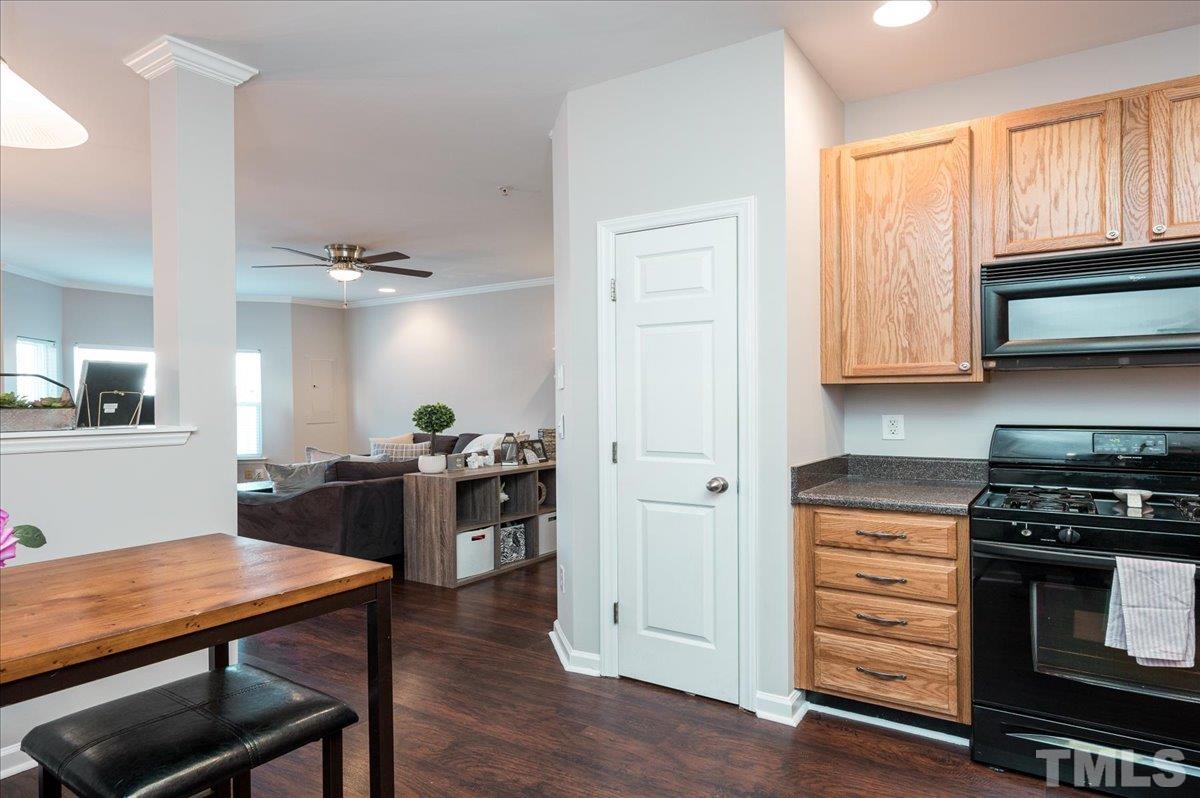 2210 Raven Road, Unit 108 Raleigh, NC 27614 - Photo 12 of 22 a kitchen with a stove and wooden floor