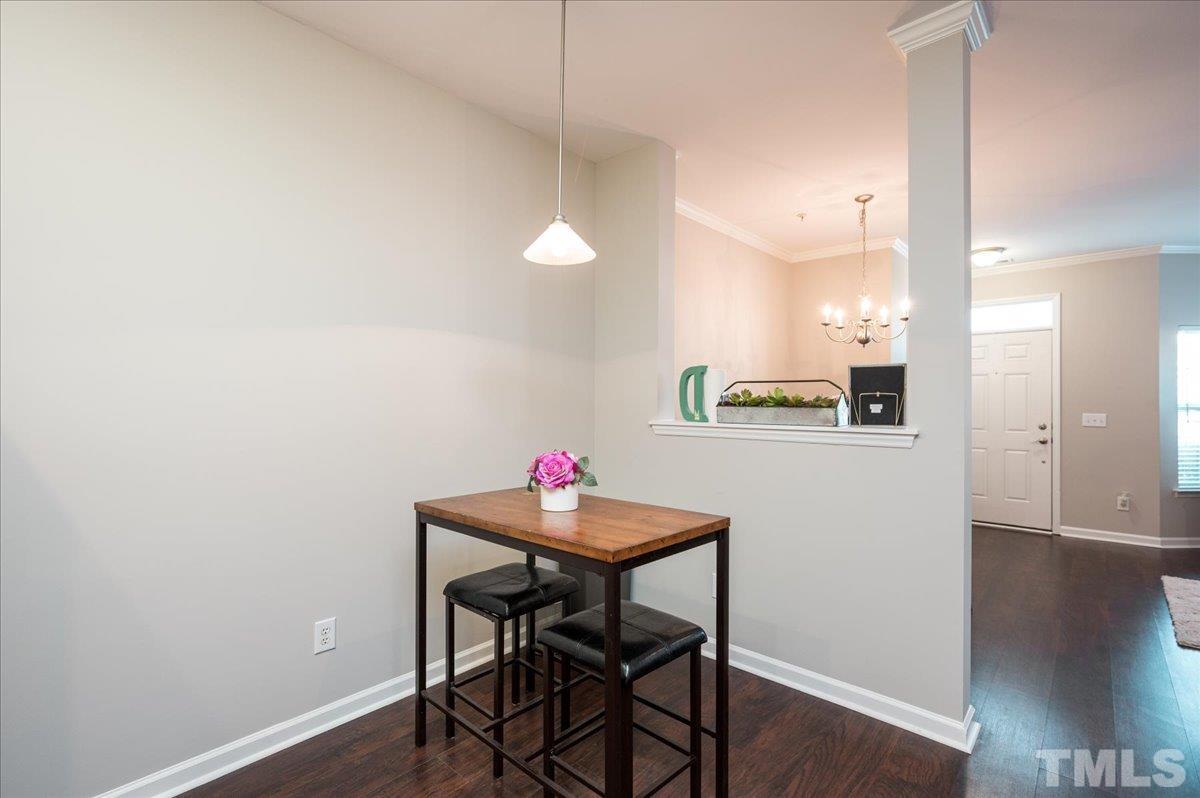 2210 Raven Road, Unit 108 Raleigh, NC 27614 - Photo 13 of 22 a view of a dining room with furniture and wooden floor