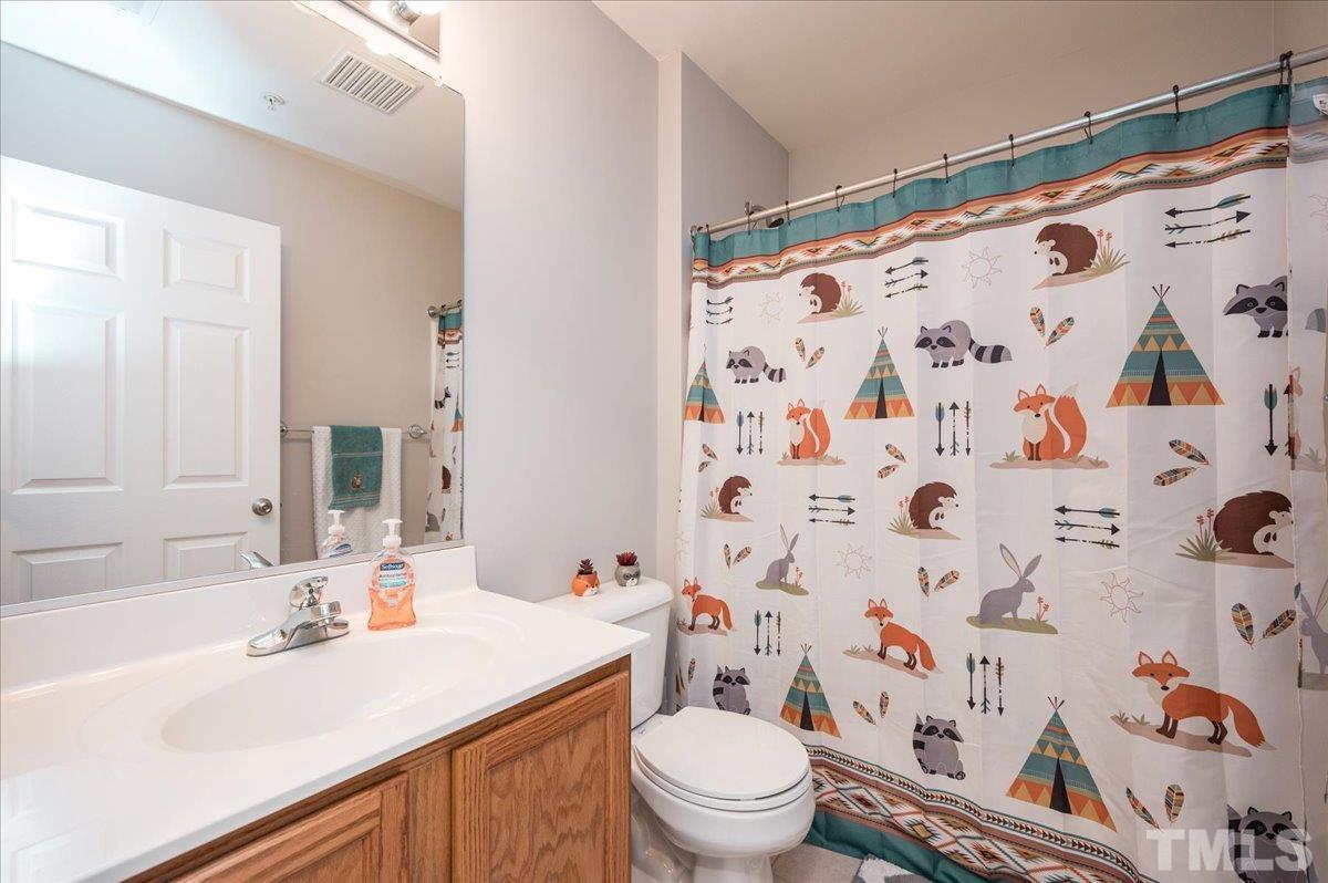 2210 Raven Road, Unit 108 Raleigh, NC 27614 - Photo 16 of 22 a bathroom with a sink a toilet and shower curtain