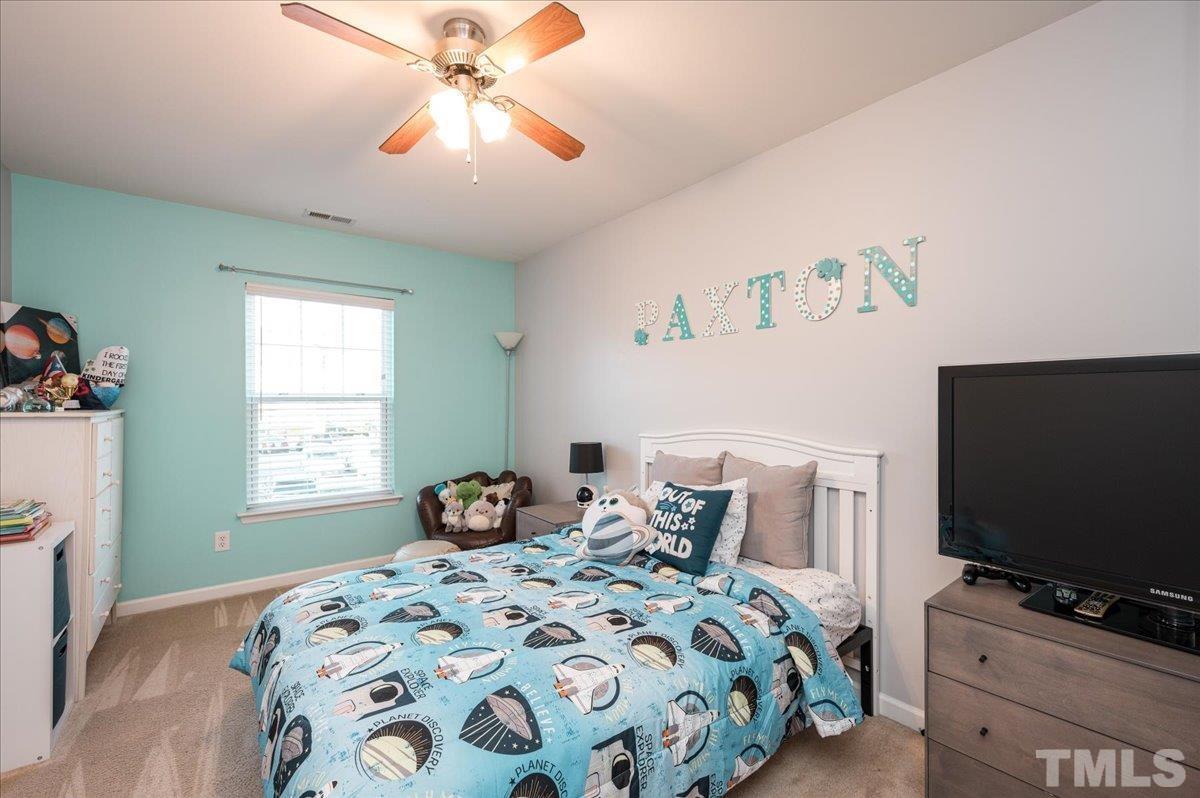 2210 Raven Road, Unit 108 Raleigh, NC 27614 - Photo 17 of 22 a bedroom with a bed and a flat screen tv