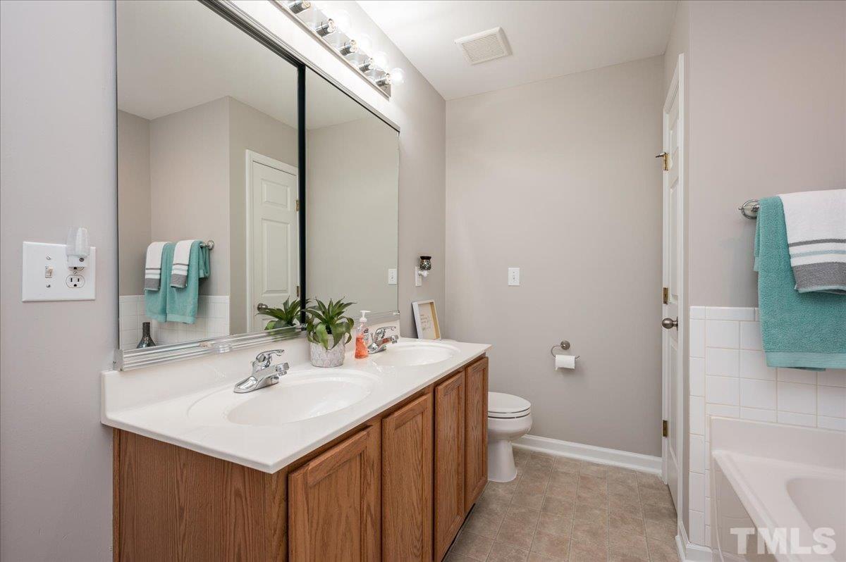 2210 Raven Road, Unit 108 Raleigh, NC 27614 - Photo 19 of 22 a bathroom with a sink a toilet and shower