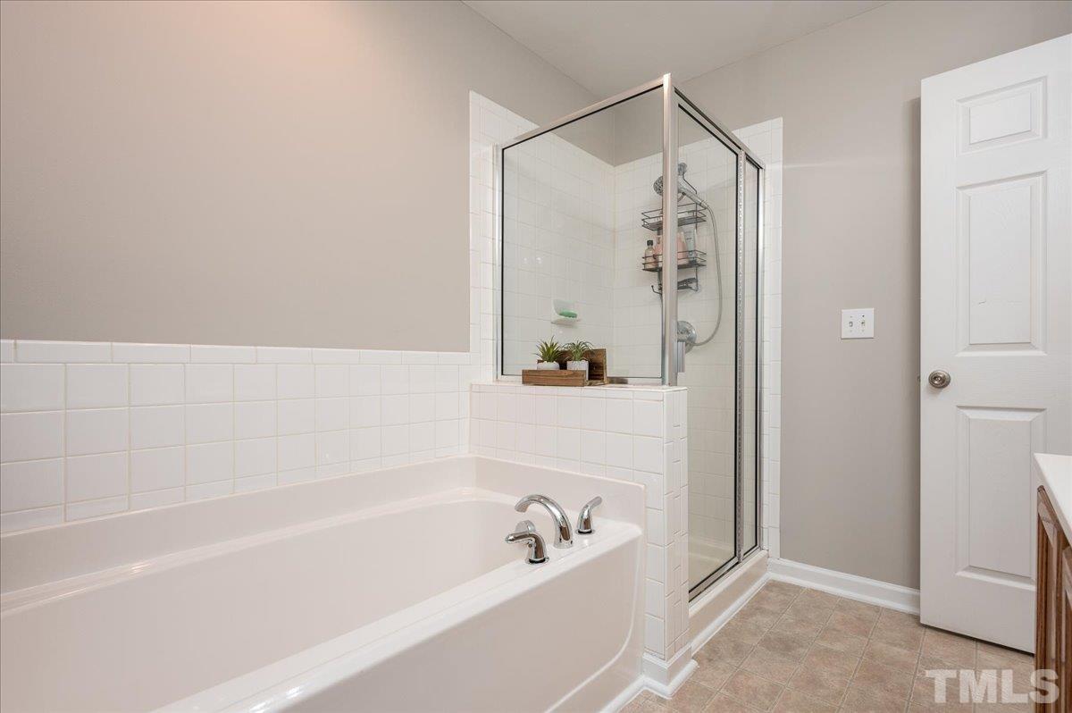 2210 Raven Road, Unit 108 Raleigh, NC 27614 - Photo 20 of 22 a bathroom with a bathtub and a shower