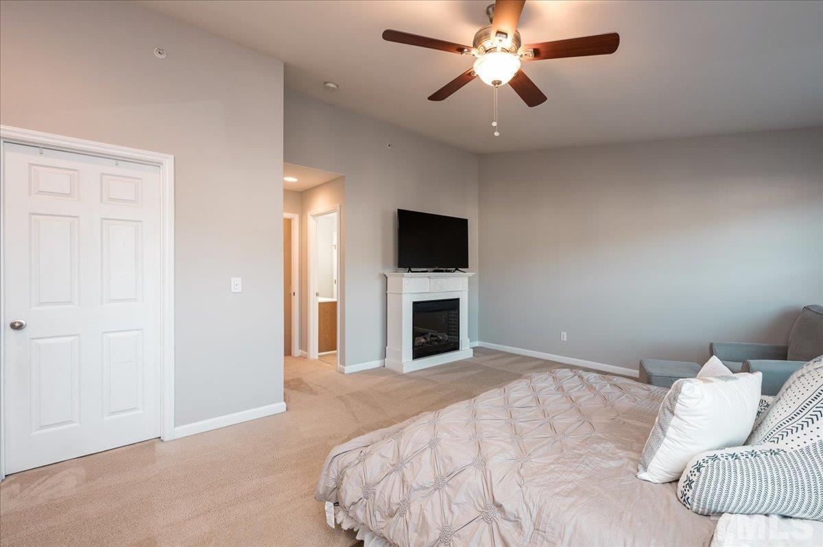 2210 Raven Road, Unit 108 Raleigh, NC 27614 - Photo 22 of 22 a bedroom with a large bed and a flat tv screen