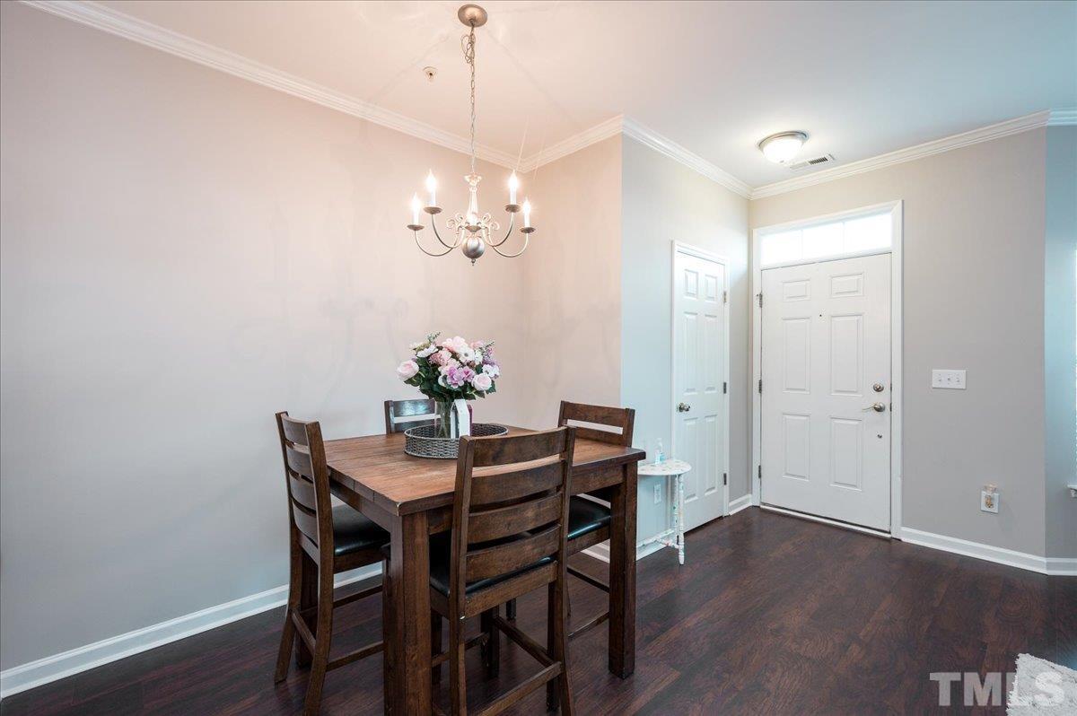 2210 Raven Road, Unit 108 Raleigh, NC 27614 - Photo 9 of 22 a view of a dining room with furniture wooden floor and a chandelier