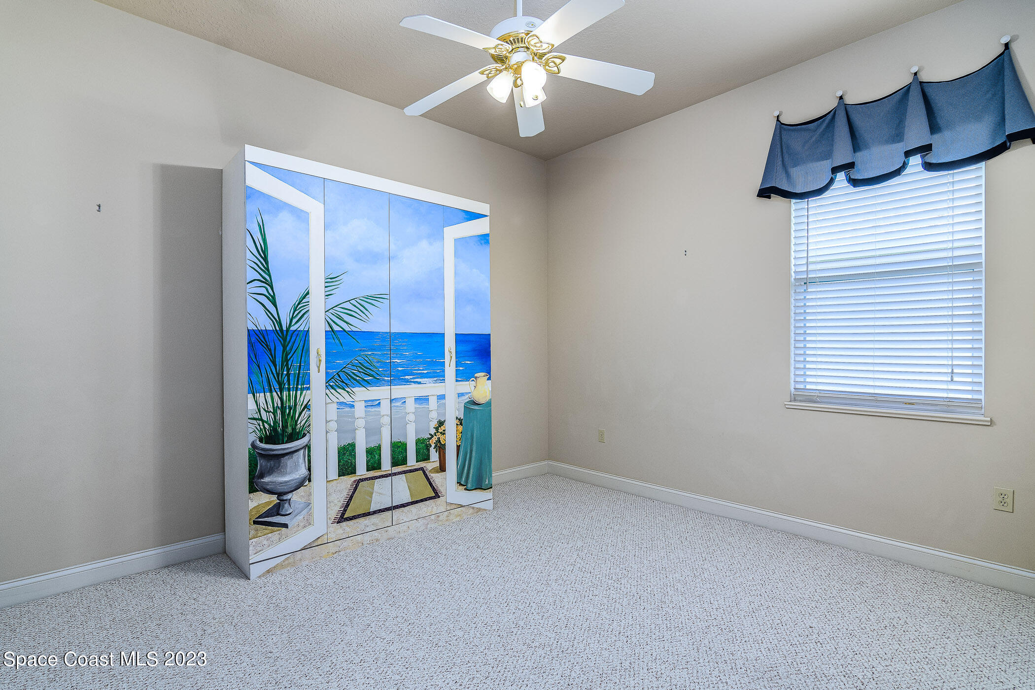 4301 Stoney Point Road Melbourne, FL 32940 - Photo 53 of 99 a view of an empty room with window and chandelier fan
