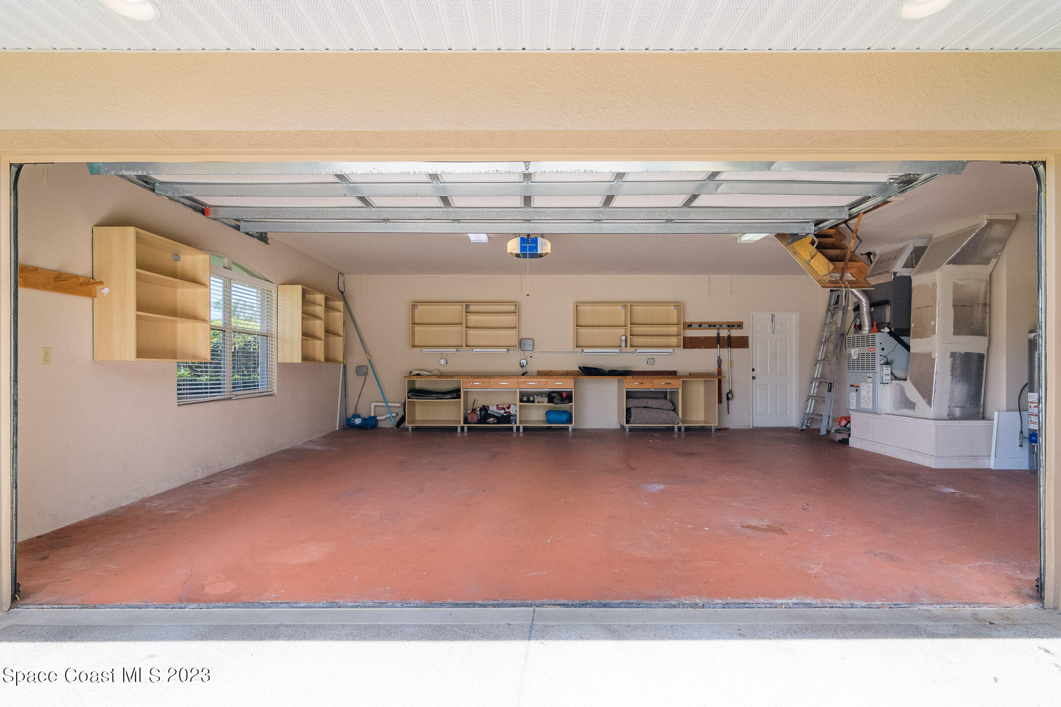 4301 Stoney Point Road Melbourne, FL 32940 - Photo 77 of 99 Garage w/ painted floors & cabinets