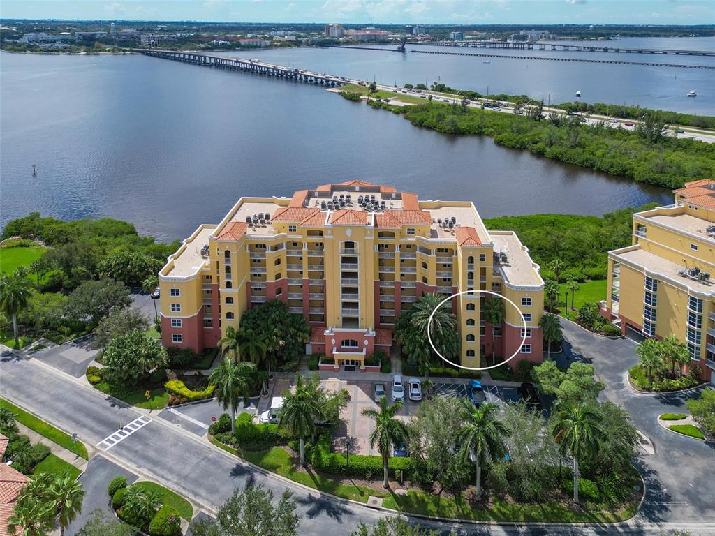 an aerial view of a house with a garden and lake view