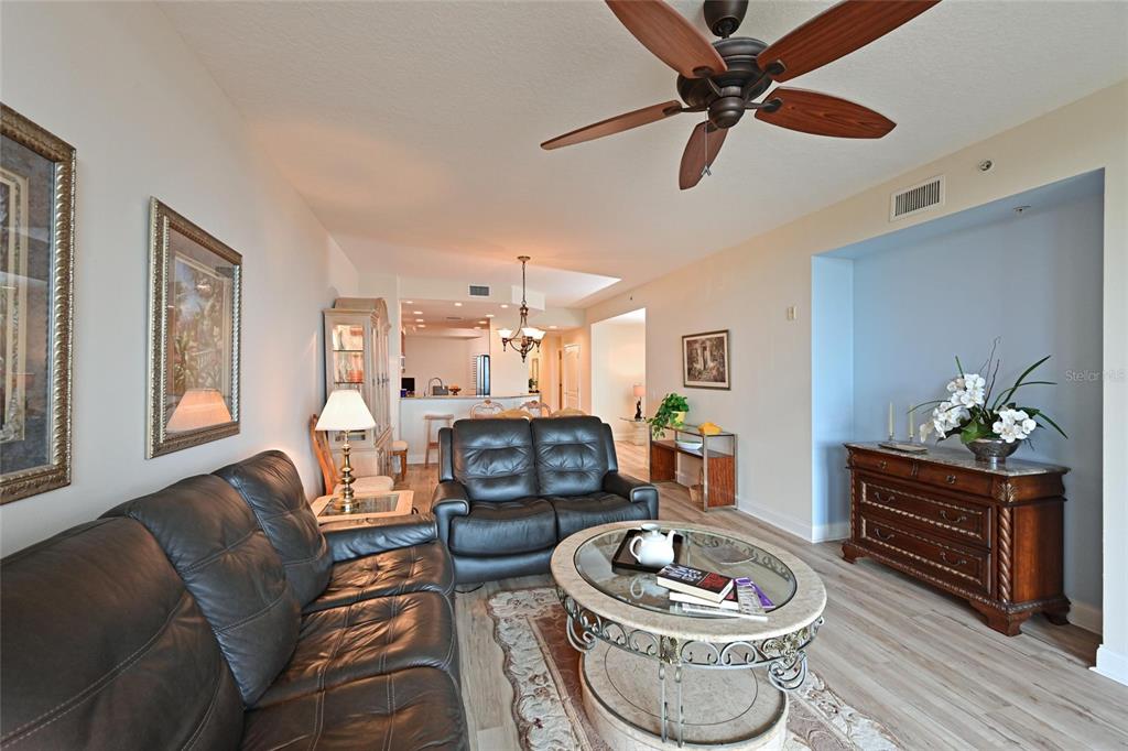 615 Riviera Dunes Way, Unit 107 Palmetto, FL 34221 - Photo 11 of 50 a living room with furniture and a wooden floor