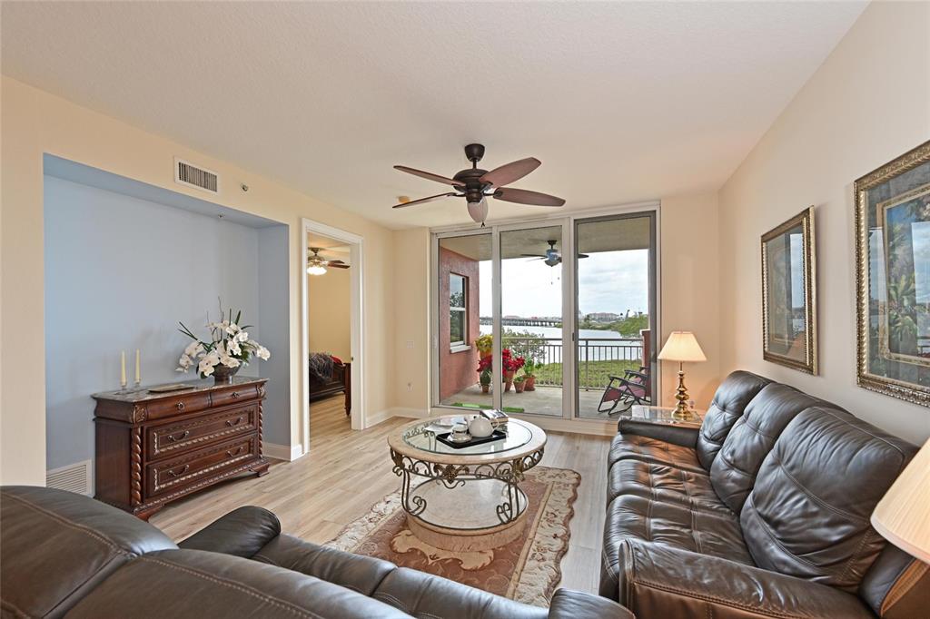 615 Riviera Dunes Way, Unit 107 Palmetto, FL 34221 - Photo 12 of 50 a living room with furniture and a large window
