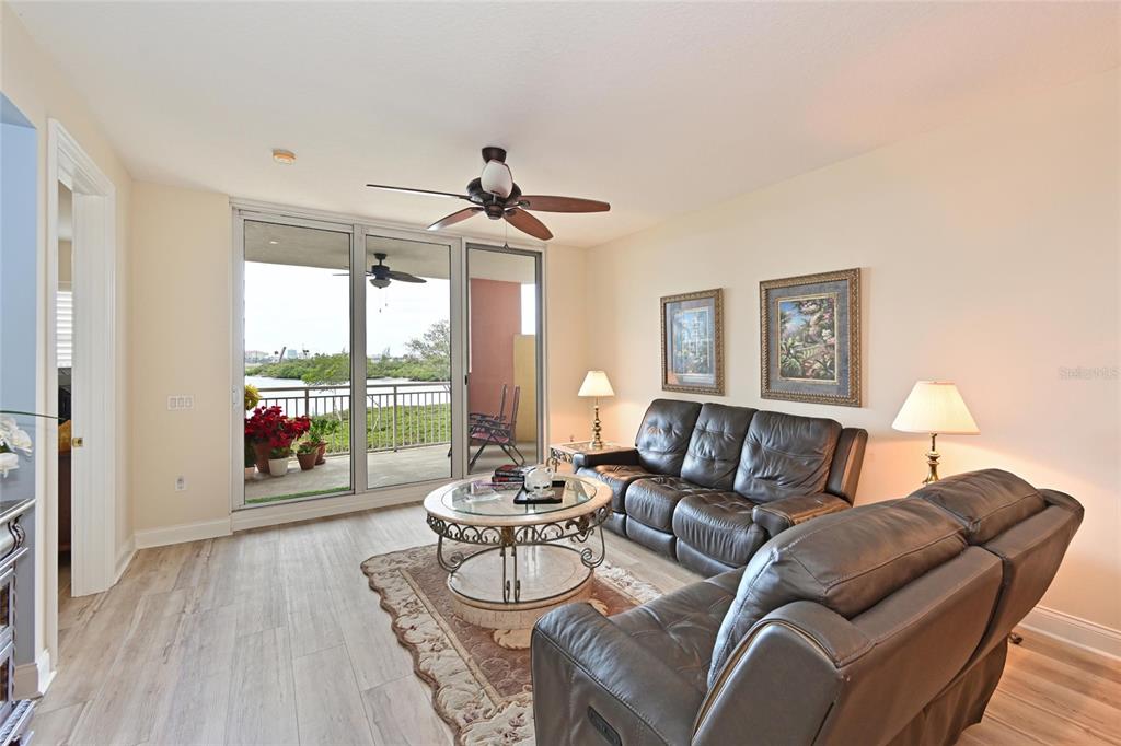 615 Riviera Dunes Way, Unit 107 Palmetto, FL 34221 - Photo 13 of 50 a living room with furniture and a large window