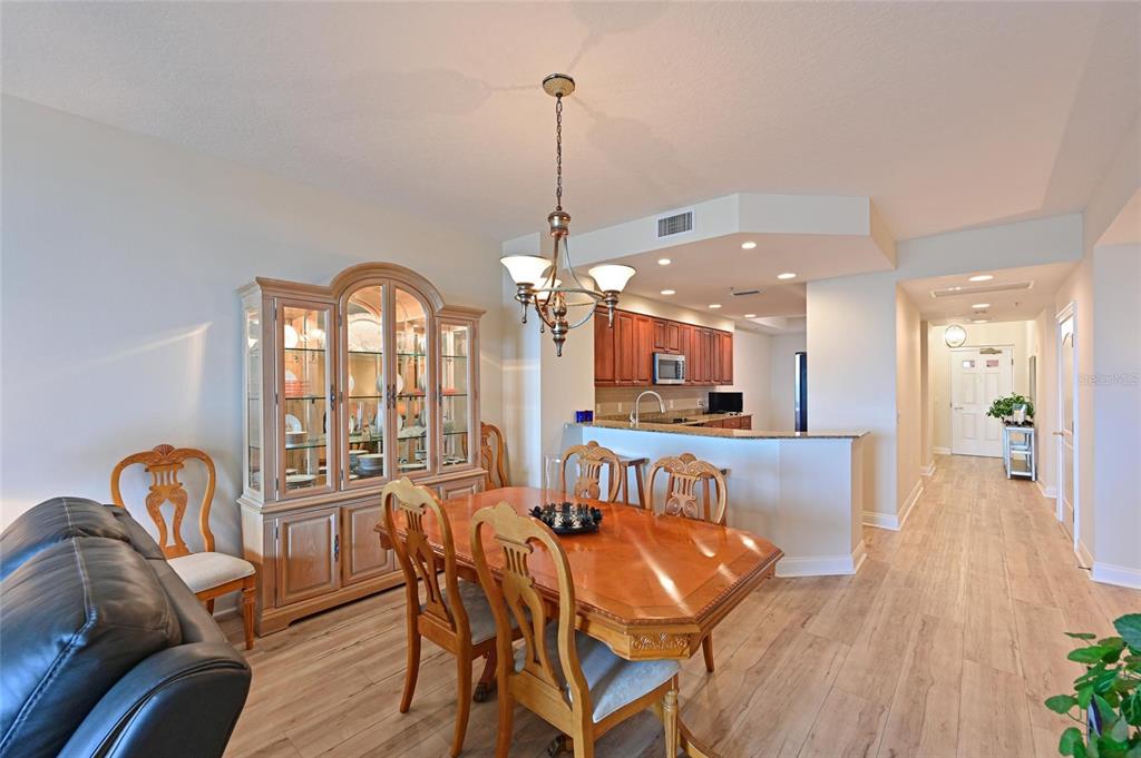 615 Riviera Dunes Way, Unit 107 Palmetto, FL 34221 - Photo 14 of 50 a view of a dining room with furniture window and wooden floor
