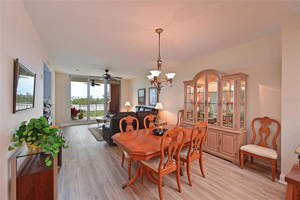 615 Riviera Dunes Way, Unit 107 Palmetto, FL 34221 - Photo 15 of 50 a view of a dining room with furniture window and wooden floor