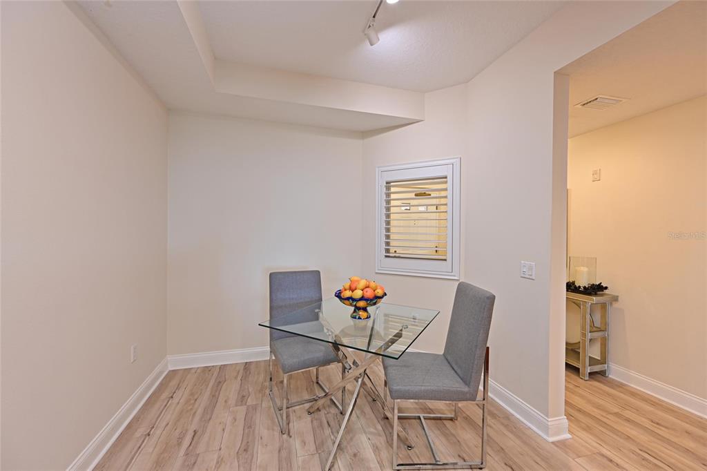615 Riviera Dunes Way, Unit 107 Palmetto, FL 34221 - Photo 22 of 50 a workspace with furniture and wooden floor