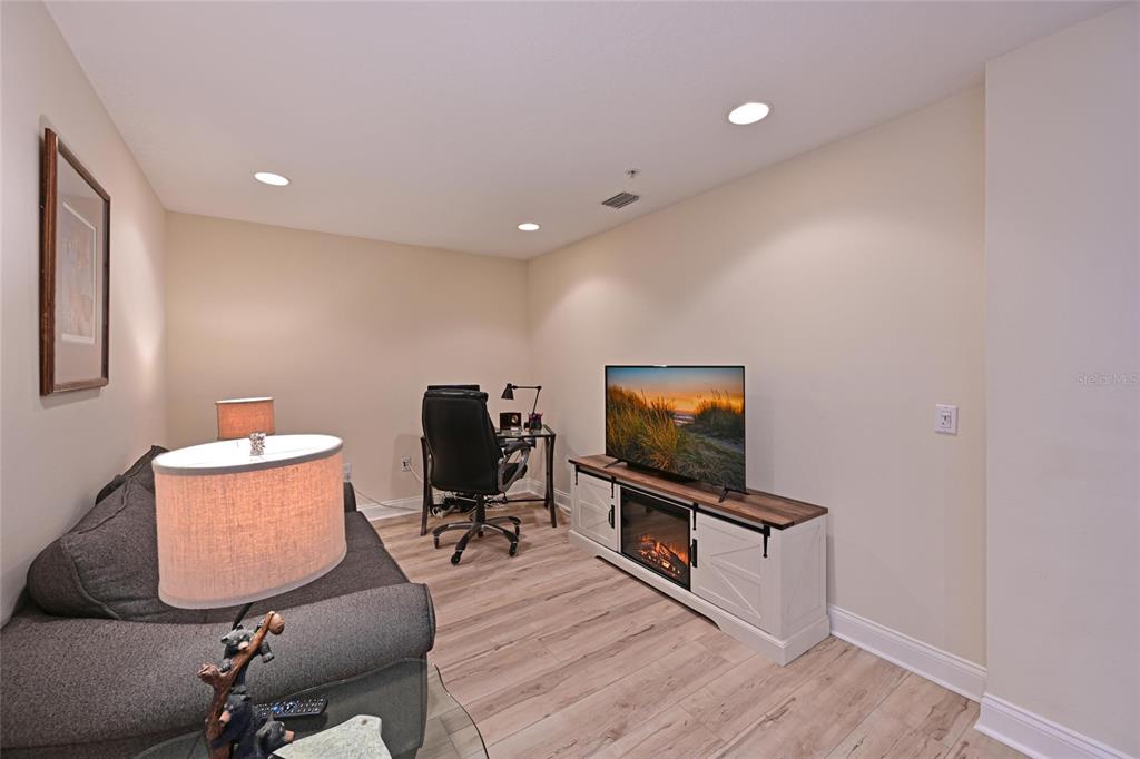 615 Riviera Dunes Way, Unit 107 Palmetto, FL 34221 - Photo 23 of 50 a living room with furniture and a flat screen tv