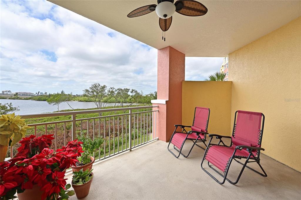 615 Riviera Dunes Way, Unit 107 Palmetto, FL 34221 - Photo 25 of 50 a view of a chairs and table in the terrace