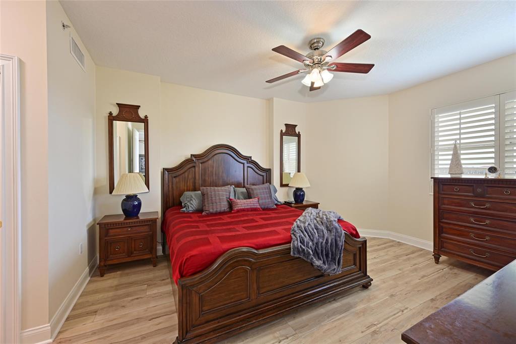 615 Riviera Dunes Way, Unit 107 Palmetto, FL 34221 - Photo 28 of 50 a bedroom with a bed and a ceiling fan