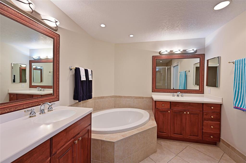 615 Riviera Dunes Way, Unit 107 Palmetto, FL 34221 - Photo 31 of 50 a bathroom with a sink and a mirror