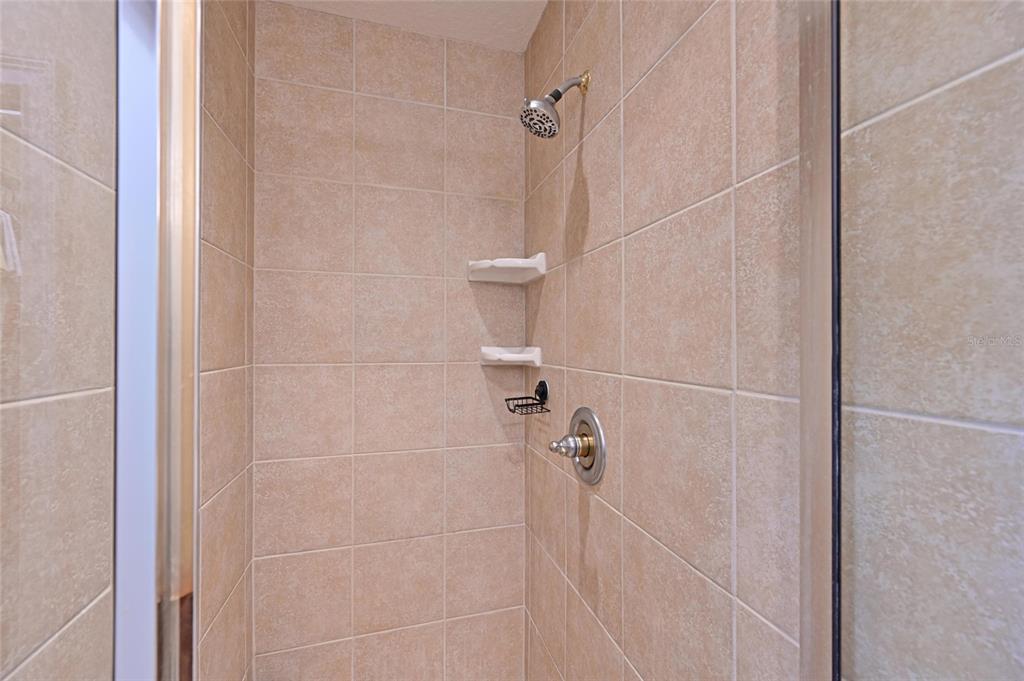 615 Riviera Dunes Way, Unit 107 Palmetto, FL 34221 - Photo 32 of 50 a bathroom with a shower