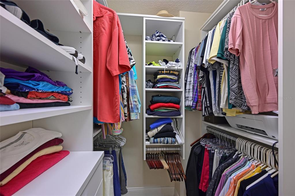 615 Riviera Dunes Way, Unit 107 Palmetto, FL 34221 - Photo 33 of 50 a view of walk in closet with clothes and shoes