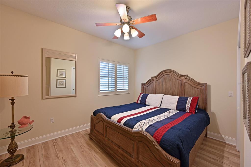 615 Riviera Dunes Way, Unit 107 Palmetto, FL 34221 - Photo 35 of 50 a bedroom with a bed and a chandelier