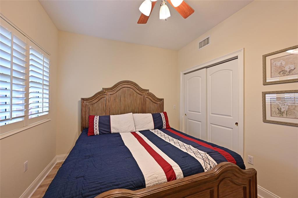 615 Riviera Dunes Way, Unit 107 Palmetto, FL 34221 - Photo 36 of 50 a bedroom with a bed and a window