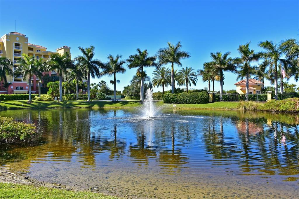 615 Riviera Dunes Way, Unit 107 Palmetto, FL 34221 - Photo 42 of 50 a view of a lake with a building in the background