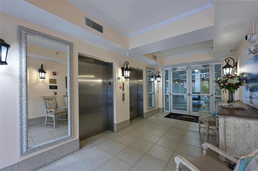 615 Riviera Dunes Way, Unit 107 Palmetto, FL 34221 - Photo 9 of 50 a view of a livingroom with a dinning area walk in closet and chandelier