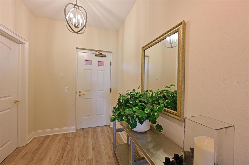 615 Riviera Dunes Way, Unit 107 Palmetto, FL 34221 - Photo 10 of 50 a view of an entryway with wooden floor