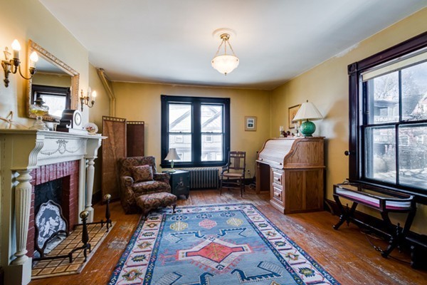 94 Rockview Street Boston, MA 02130 - Photo 16 of 24 a bedroom with furniture and a fireplace