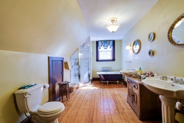 94 Rockview Street Boston, MA 02130 - Photo 22 of 24 a bathroom with a toilet sink and mirror