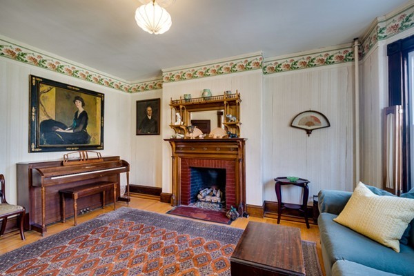 94 Rockview Street Boston, MA 02130 - Photo 5 of 24 a living room with furniture a flat screen tv and a fireplace