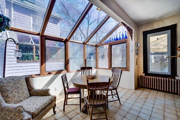 94 Rockview Street Boston, MA 02130 - Photo 10 of 24 a view of a dining room with furniture wooden floor and a potted plant