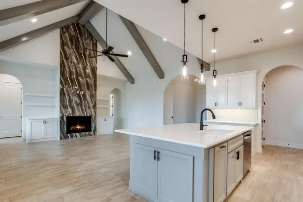 a kitchen with a sink and a fireplace